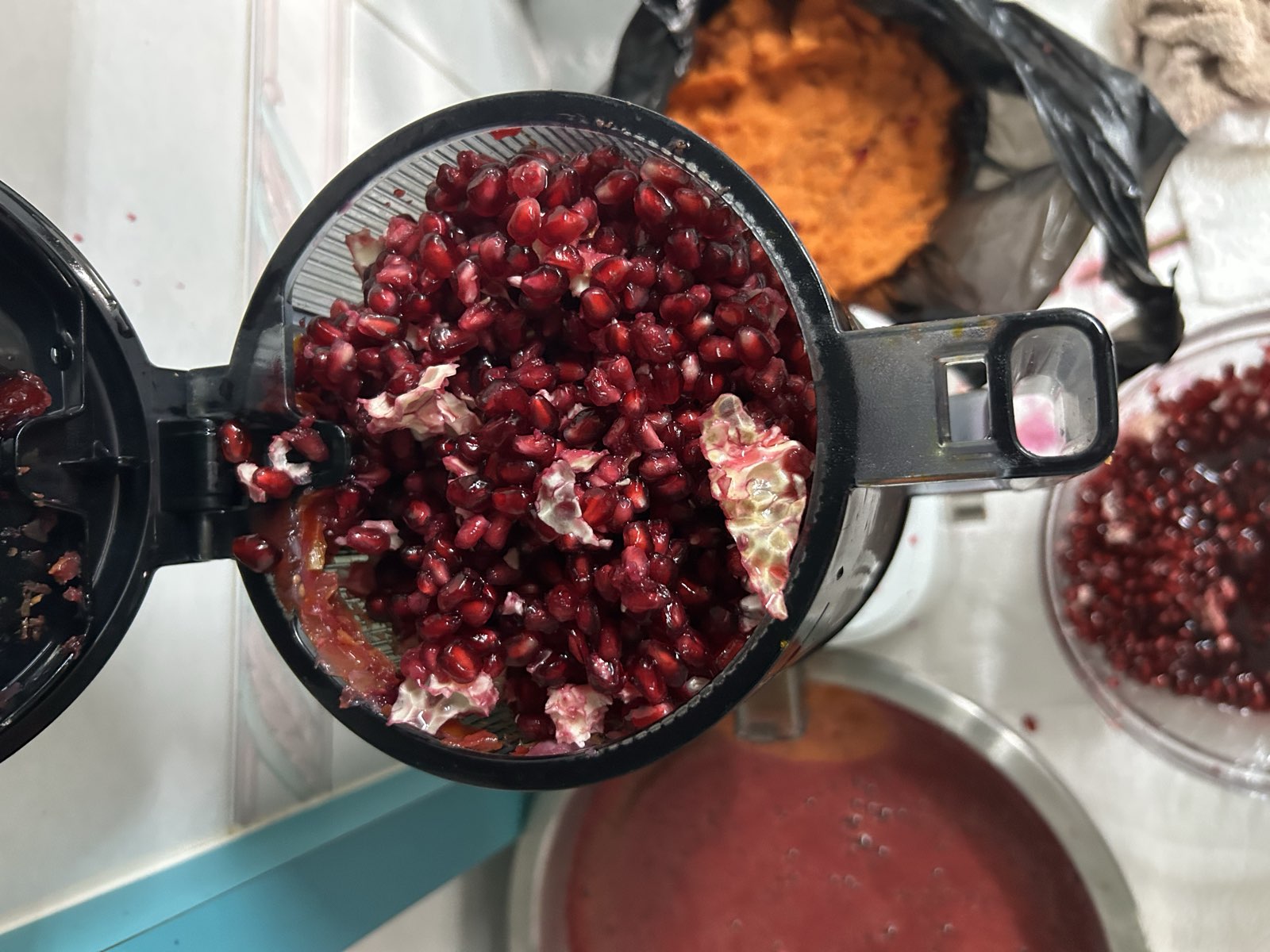 The juicer loaded with pomegranate